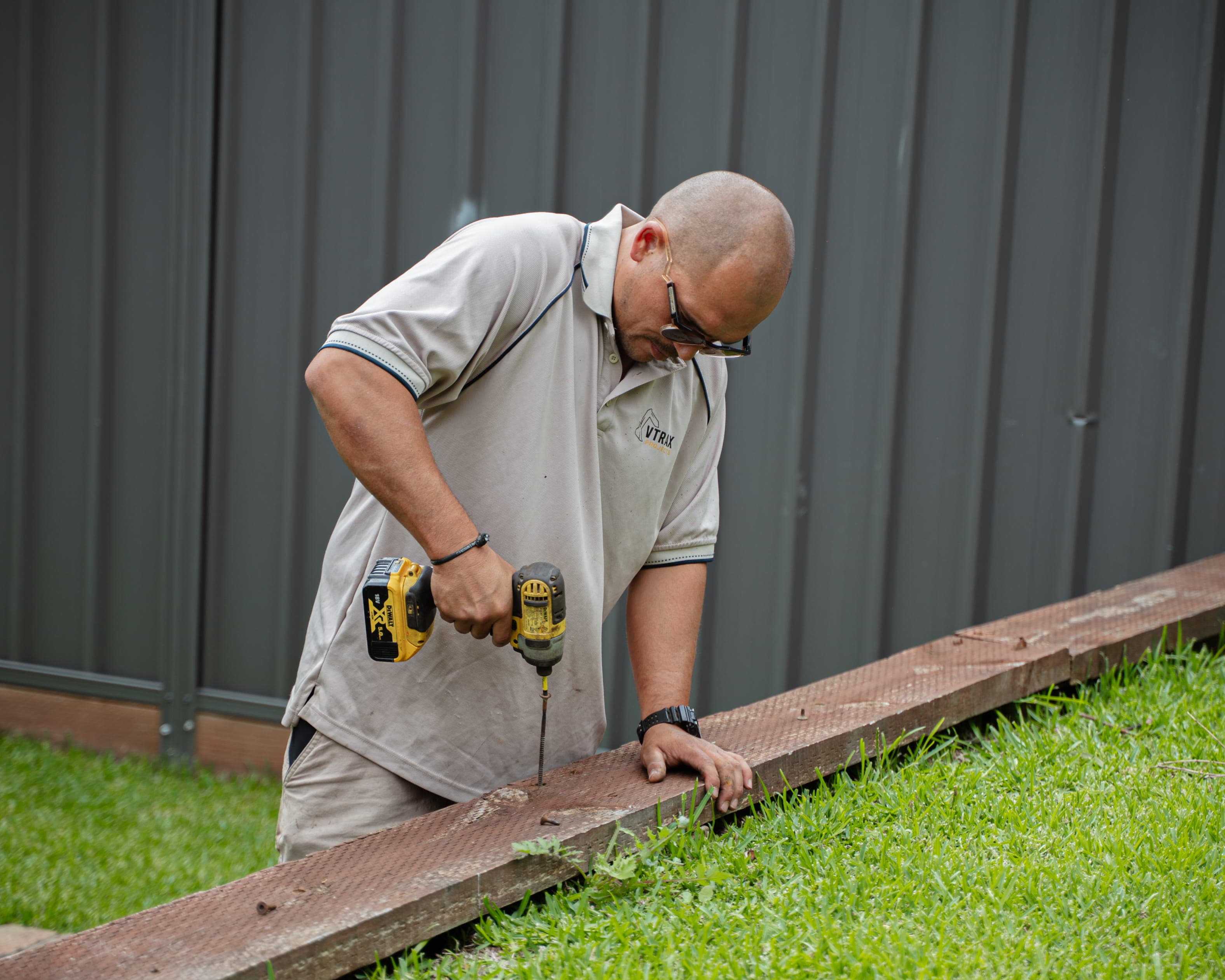 Workers installing concrete blocks for wall